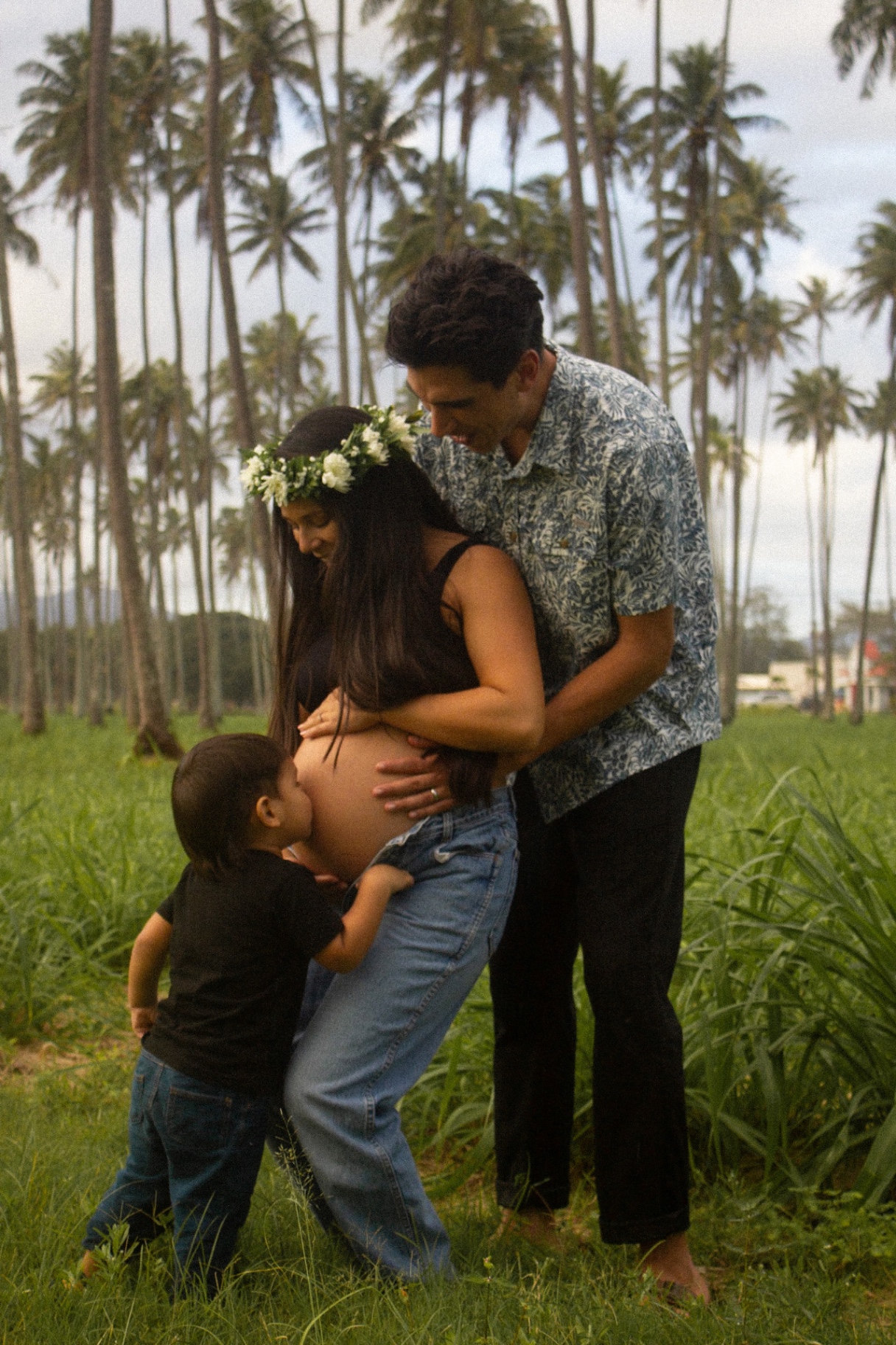Maternity portrait with family among palm trees