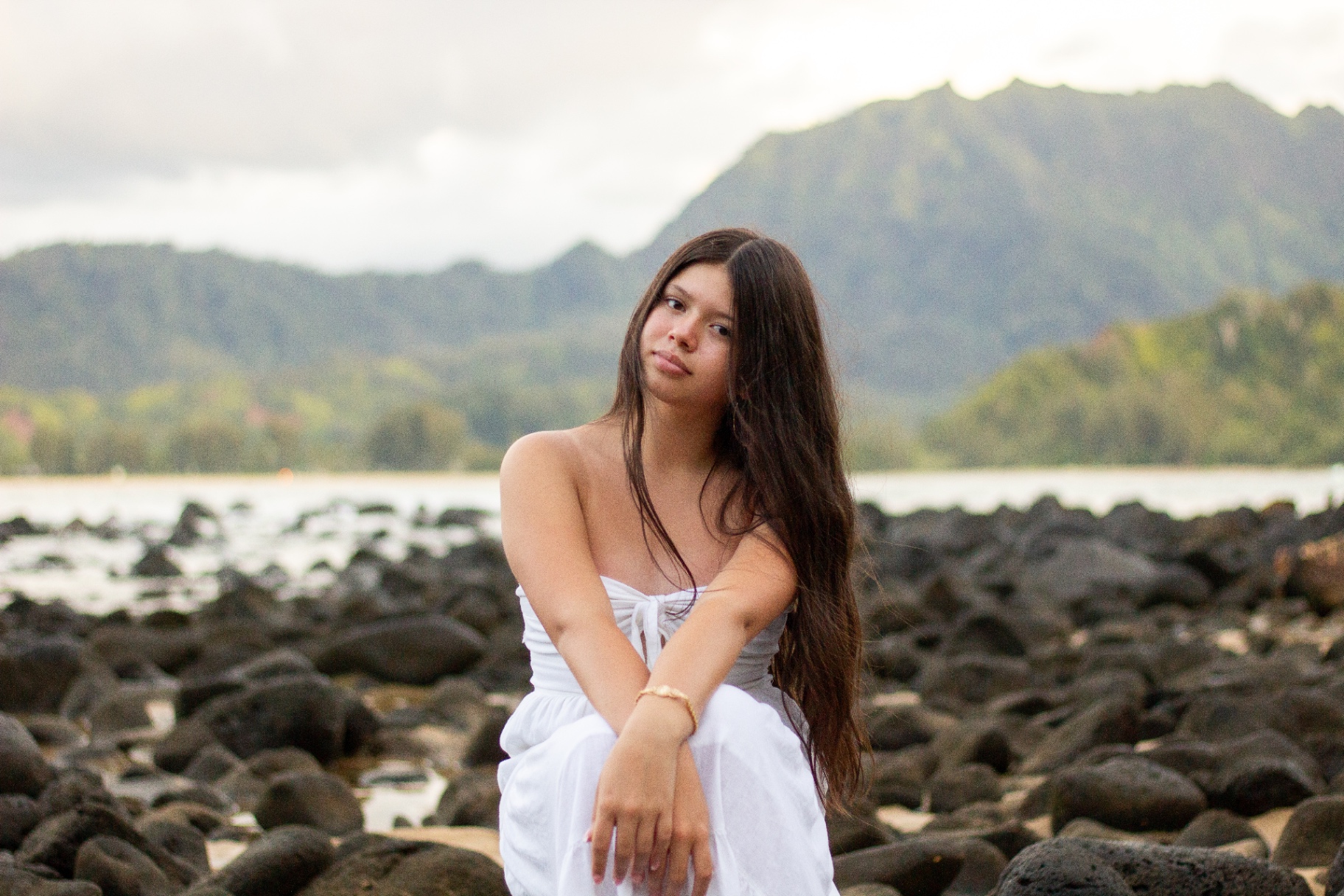 Portrait on the rocky shore with Hanalei mountains, Kauaʻi
