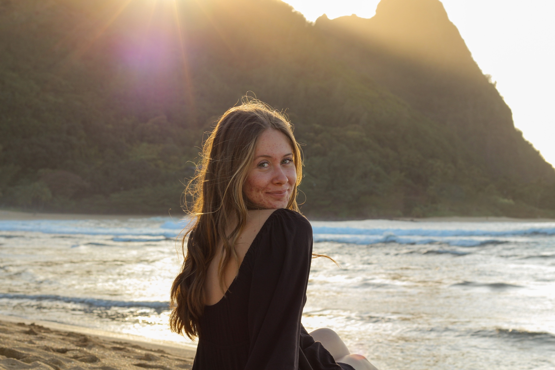 Portrait on the beach with sun flare over Bali Hai mountain, Kauaʻi